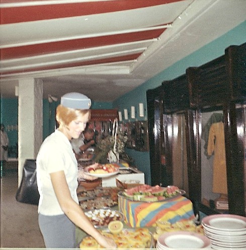 1967 Bernadette Degroote enjoys a hotel buffet lunch during a multi-hour transit on St. Croix